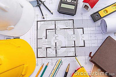 Architect desk with blueprint and hard hat constuction building Stock Photo