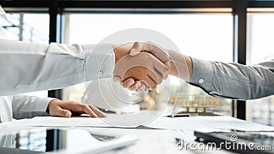 Architect and engineer construction workers shaking hands while working for teamwork and cooperation concept after finish an agree Stock Photo