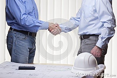 Architect or engineer doing handshake with partner Stock Photo