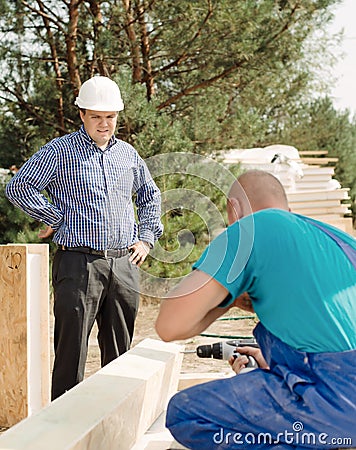 Architect or foreman watching a builder Stock Photo