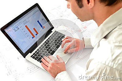 Architect at his workplace with notebook - house building and co Stock Photo