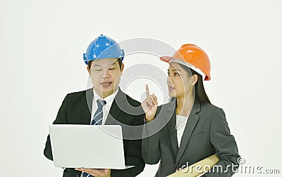 Architect man and woman wearing colorful helmet diccusing for work in whitre background Stock Photo