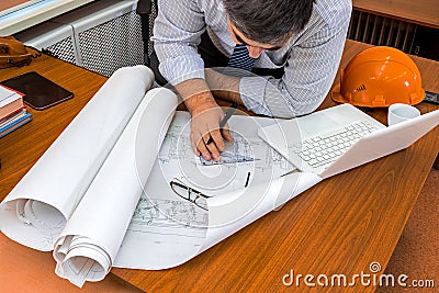 Architect man working with laptop and blueprints Stock Photo
