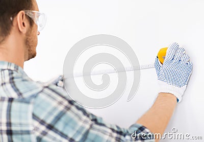 Architect measuring wall with flexible ruler Stock Photo