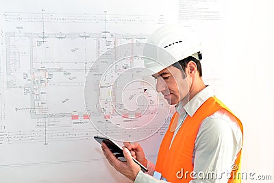 Architect planning a house on the ground plan Stock Photo