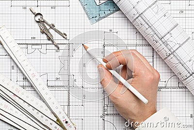 Architect pointing on architectural blueprint house building plan with pencil, ruler, compasses and square flatlay Stock Photo