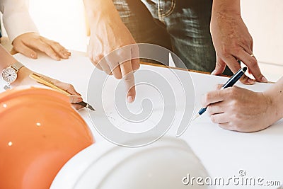 Architect Team Brainstorming Planning Design, Civil engineer sketching a blueprint of construction project with small house model Stock Photo