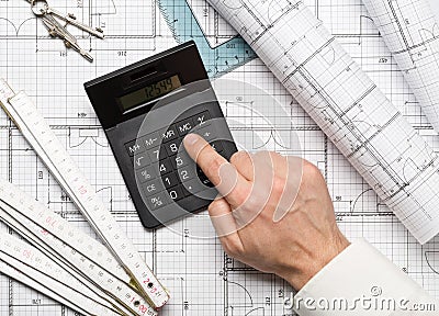 Architect using calculator on architectural blueprint house building plan with pencil, ruler, compasses and square flatlay Stock Photo