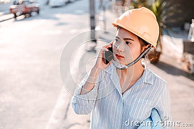 Architect woman use mobile phone call with enginner or project manager between survey and checking at site construction. Architect Stock Photo