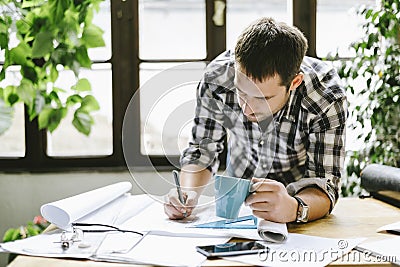 Architect working on freelance renovation project in his cool home office studio Stock Photo