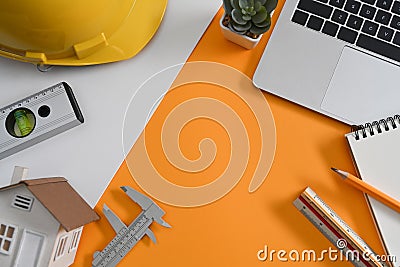 Architect workplace with laptop, helmet and some mechanical tools. Stock Photo