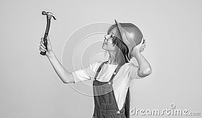 architect in workshop. renovation and repair. using working tool. teen girl in helmet with hammer. child wear hard hat Stock Photo