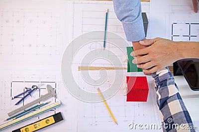 Architects and construction engineering handshake after meeting discuss structural blueprints calculate project completion. Stock Photo