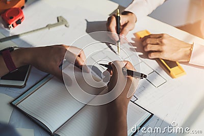 Architects meeting about construction project of house with blueprints in office. Construction and structure concept Stock Photo