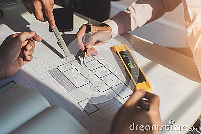 Architects meeting about construction project of house with blueprints in office. Construction and structure concept Stock Photo