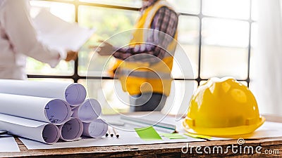 Architects talking at the table Teamwork and Workflow Creation Concepts, Close-up of Person Engineer`s Hand Drawn Plan on Blue Stock Photo