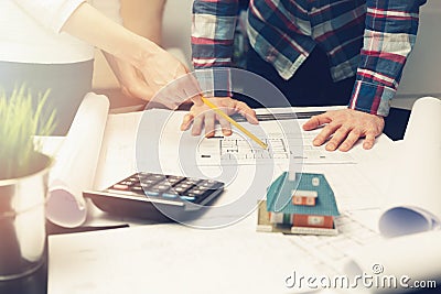 Architects team working with new house project blueprints Stock Photo