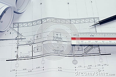 Architectural blueprints and blueprint rolls and a drawing instruments on the worktable Stock Photo