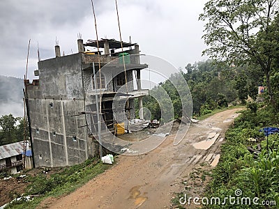 Architectural building in a hill of Clouds and Trees Stock Photo