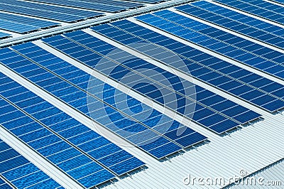 Architectural detail of metal roofing on commercial construction Solar panels or Solar cells on factory rooftop or terrace with su Stock Photo
