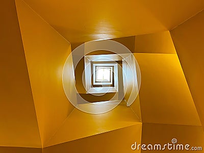 Architectural Elegance: Squared Spiral Staircase from Below Stock Photo