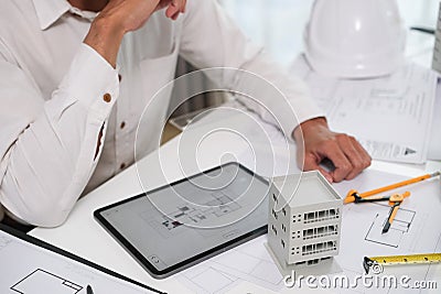 Architectural engineer man using digital tablet on workspace Stock Photo