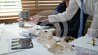 Architectural engineers discussion with planing construction on workspace Stock Photo