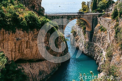 Architectural landmark, stone bridge. A view of the Fiordo of Furore in Amalfi coast, Travel and vacation concept. Summer day. Stock Photo