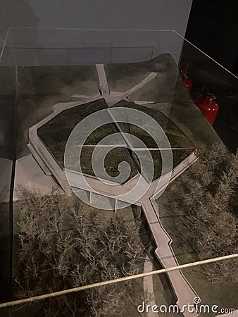 Architectural model within glass casing, multi-level structure with connecting pathways, modern design featuring flat Editorial Stock Photo