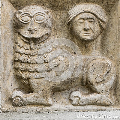 Ancient greco roman relief of mythical lion and human head build into wall Stock Photo