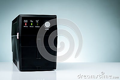 Uninterruptible power supply. Backup Power UPS with battery isolated on table. UPS for PC. Equipment for computer system Stock Photo