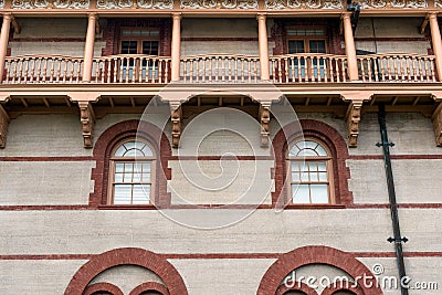 Architecture of brick outlined windows and wooden balcony Stock Photo