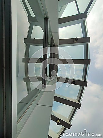 The architecture of the building has a minimalist nuance with a combination of white and glass. Stock Photo