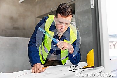 male architect with blueprint and ruler at office Stock Photo