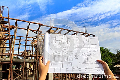 architecture drawings in hand on house building ba Stock Photo