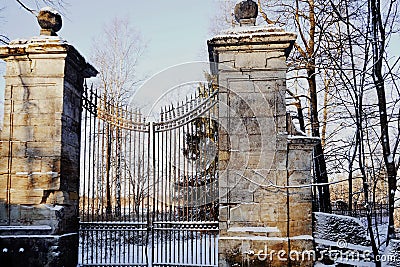 architecture gates park sky trees sunlight winter snow cold day Stock Photo