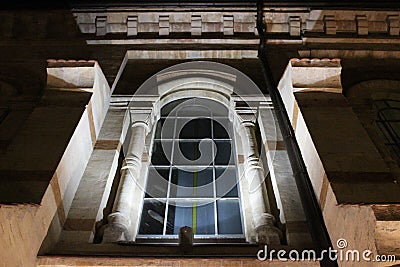 The architecture of the old building in the shadows of the night lights. Stock Photo