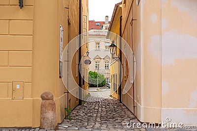 The architecture of the strago city of Prague. Old european streets, yellow low buildings and stone paving stones Editorial Stock Photo