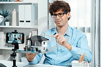 Architecture using house model to teach architect by smartphone. Gusher. Stock Photo
