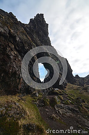 Archway Rock Formation on Black Sand Beach Stock Photo