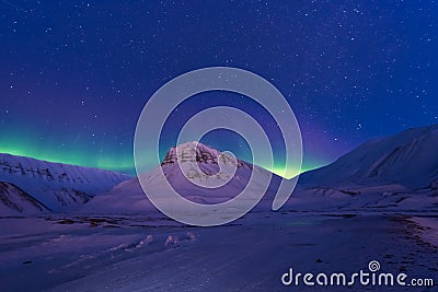 Arctic Northern lights aurora borealis sky star in Norway Svalbard in Longyearbyen city mountains Stock Photo