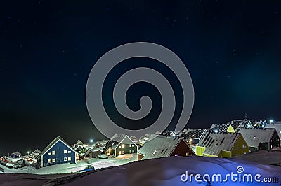 Arctic polar night over colorful inuit houses in a suburb of arc Stock Photo