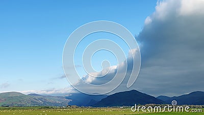 Arcus cloud formation in the form of shelf or rolling clouds over rural mountain landscape Stock Photo