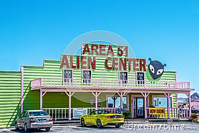 Area 51 Alien Center convience store and gas station on highway from Vegas to Death Valley with alien decor - yellow convertable p Editorial Stock Photo