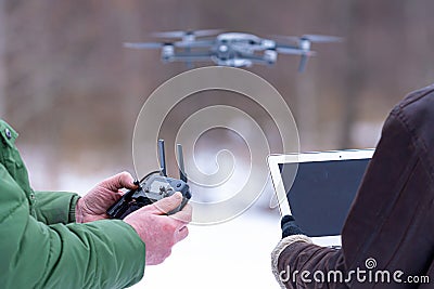 Area planners survey the surroundings with a drone, hands with drone remote controller and a laptop Stock Photo