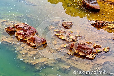 Colorful river rocks background in The river Odiel. Huelva, Andalucia, Spain Stock Photo