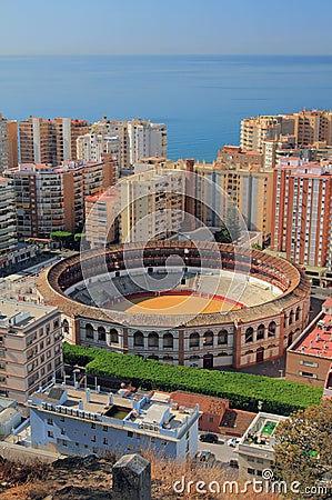 Arena for bullfight and city on sea coast. Malaga, Spain Stock Photo