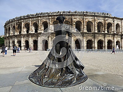 France. Gard. Nimes. The arenas and the statue of Nimeno II Editorial Stock Photo