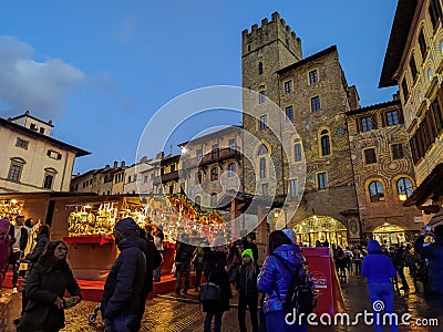 AREZZO, ITALY - NOVEMBER 26, 2022: View of the tyrolean christmas market in the center of Arezzo city during dusk, Italy Editorial Stock Photo