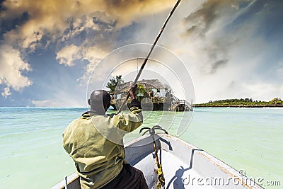 Arfican on the boat sailing to tha Rock restaurant in ocean Editorial Stock Photo